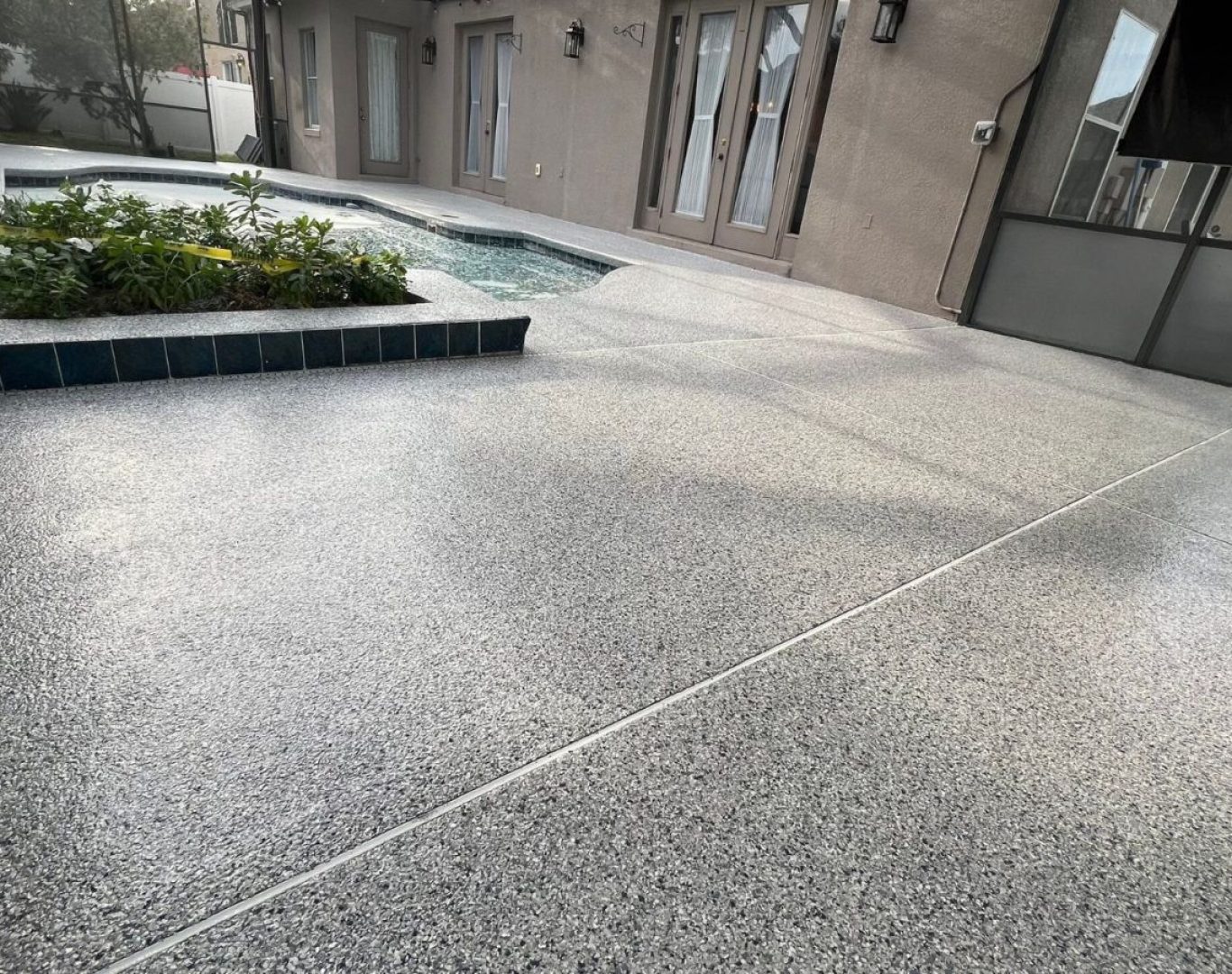 Colorful Concrete Solutions team applies concrete coatings in Waukesha County, WI, showcasing local expertise and tools.