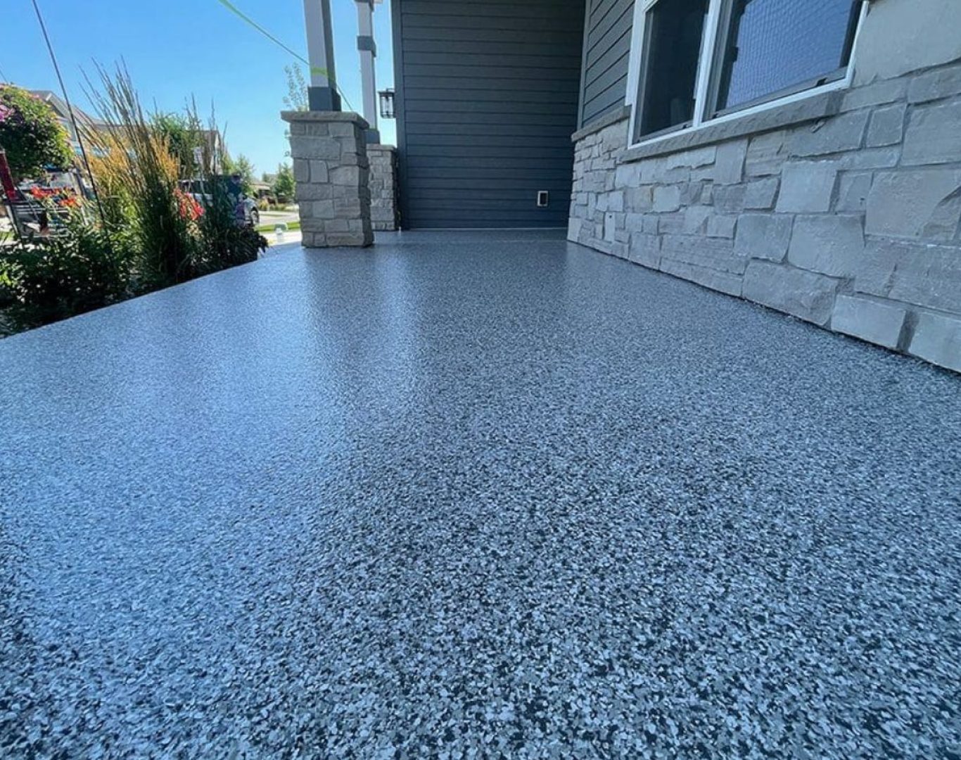 A Colorful Concrete Solutions technician applies durable concrete coatings in Brookfield, WI, using professional tools to deliver long-lasting local results.